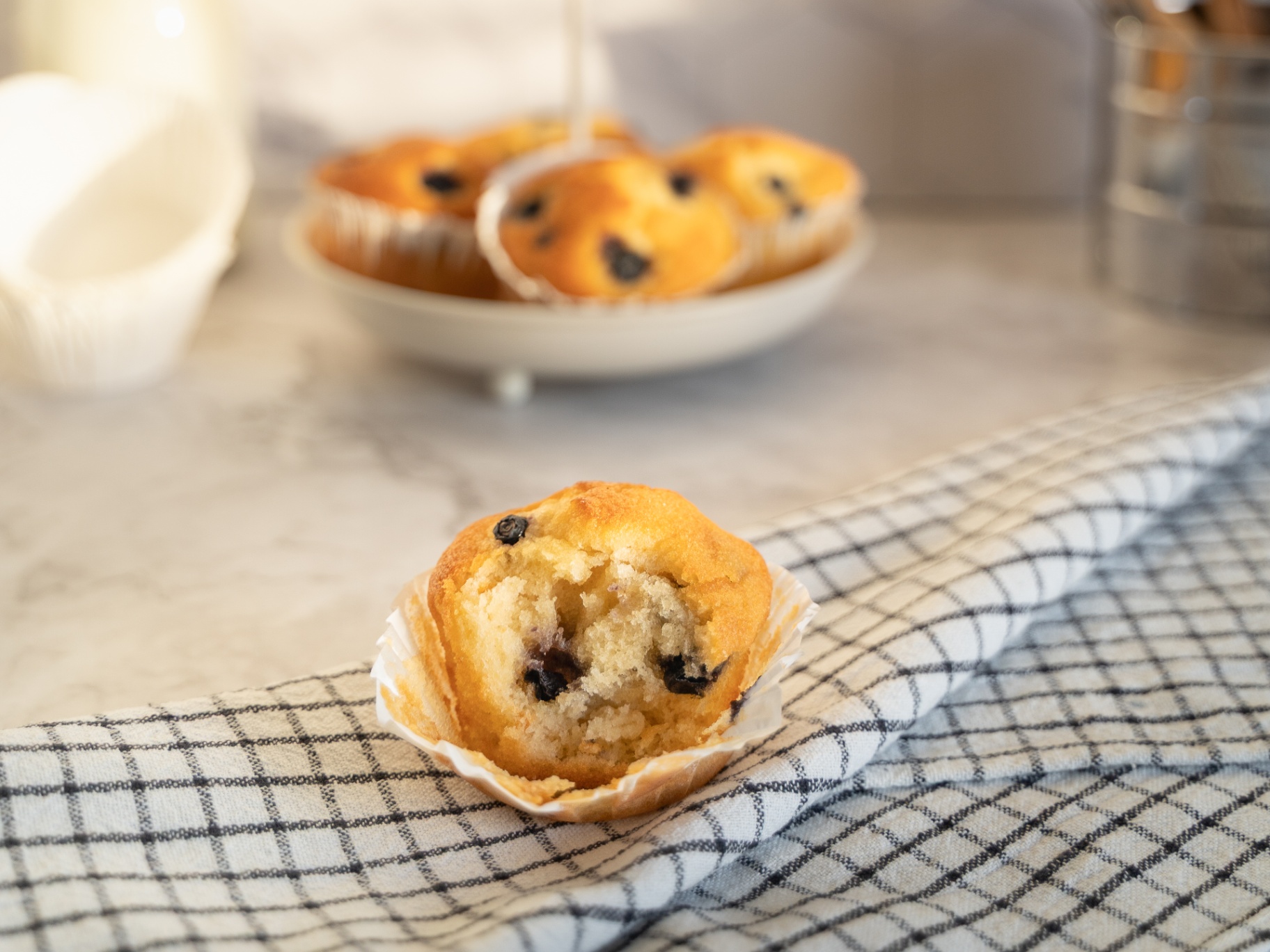 Single muffin on linen — Bakery Notes