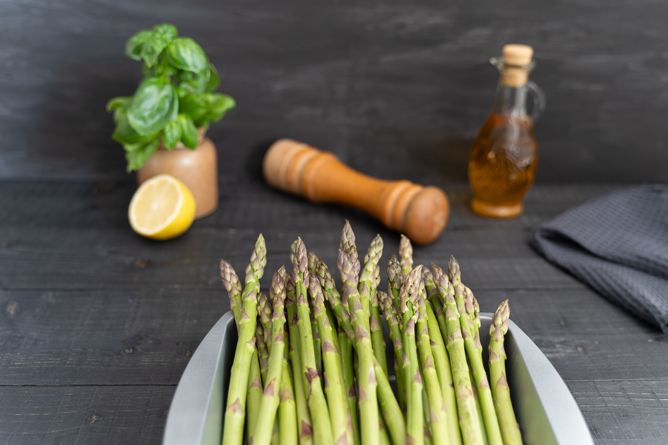 Raw asparagus in metal roasting pan — Greens & Salads