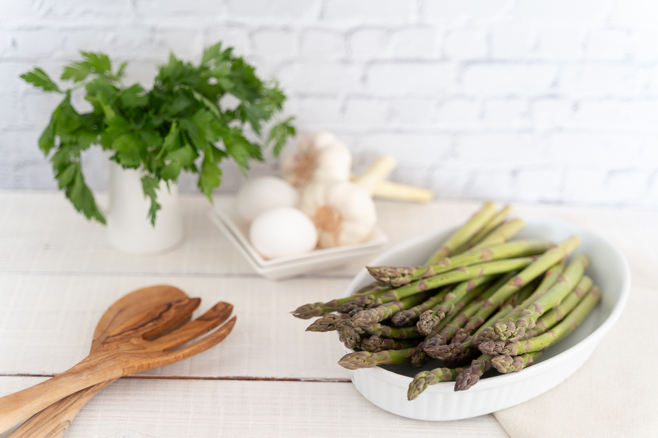Asparagus in white dish with eggs and herbs — Green Kitchen